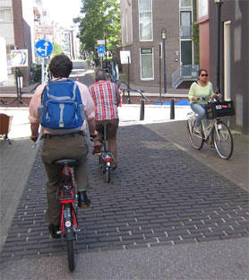 This picture shows people riding bikes in a bike lane.