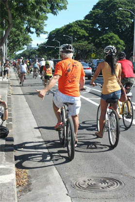 Image of many bicyclists in a bike lane.