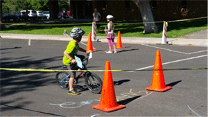 Image shows traffic cones blocking off an area for children learning to bike.