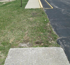 Image shows a gap in a sidewalk.