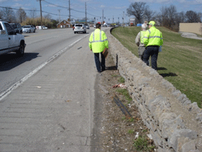 Image shows assessment participants walking along a roadway with no sidewalk.
