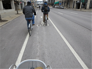 Image shows bicyclists in a bicycle lane.
