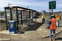 Image shows assessment participants near a bus shelter.