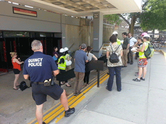 Image shows a scene of assessment participants outside a transit station.