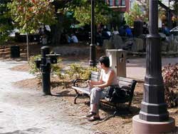 Photo of person sitting on park bench.