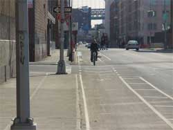 Photo of bicyclist riding on isde of road contraflow.