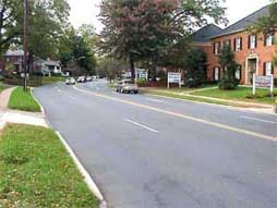 Photo of a road with small sidewalk.