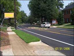 Photo of a road with larger sidewalk.