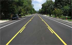 Photo of a road with center turn lane.