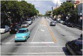 Photo of a road with no bike lanes.