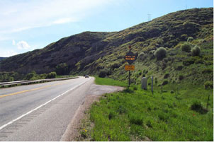 Graphic of roadway with rumble strips along roads edge.