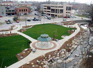 Photo of wide paved trail over water.