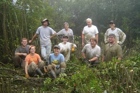 Participants in the Georgia Plant Conservation Alliance pose for a picture in a wooded area