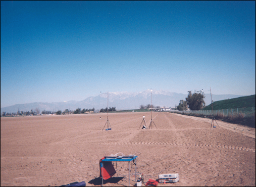 Photograph of Site 10CA showing a barren field and grassy berm.