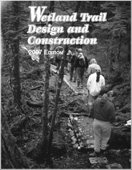 Photo of group of hikers on a singletrack trail.