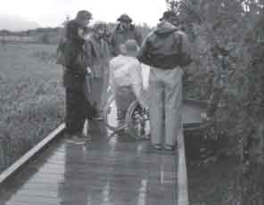 Photo of people on a boardwalk.