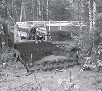 Photo of two workers installing geocells.