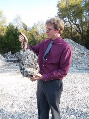 Man holding a bag of oyster shells.