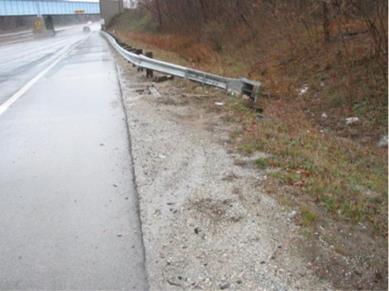 Photo 24 shows approach roadway & damaged terminal for Case #6A002