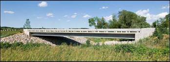 Wapello/Mars Hill Bridge, Iowa (2005) is the <em>first North American Ductal® highway bridge; a collaboration involving the FHWA, Iowa DOT, ISU and Lafarge. It is a simple, single-span with a 3-beam cross section and three 33.5 m Ductal® girders without rebar for shear stirrups. This project won a Portland Cement Association (PCA) Concrete Bridge Award.