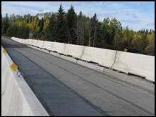 The Sunshine Creek Bridge, Ontario (2007) is a single span, box girder bridge with Ductal® Joint Fill along the length of the girders.  It is built with 10 box girders (600 mm thick) side-by-side and 9 Ductal® joints. Ductal® was also used in the approach slabs and curbs. 