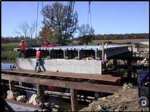 The Jakway Park Bridge, Iowa (2008) is North America's first highway bridge built with a new generation of three Ductal®  pi-girders; the first North American highway bridge to incorporate batching of Ductal® in a ready-mix truck and; the second highway bridge in Iowa and North America with Ductal® girders. This project won an Iowa Quality Initiative Structures Research Merit Award and a Precast/ Prestressed Concrete Institute (PCI) Design Award.