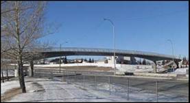The Country Hills Pedestrian Bridge, Alberta (2008) has a 33.5 m Ductal® drop-in girder.  This 49 m clear span bridge crosses over 6 lanes of traffic, providing the two adjacent communities with an aesthetically pleasing, durable curved-linear link.  This is the first pedestrian bridge project where Ductal® was batched in a ready mix truck.