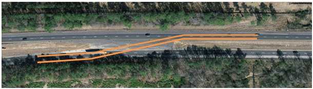 Figure 8. Photo. Aerial view of northern crossover. Southbound traffic shifts to northbound side divided by a jersey barrier. Figure 8. Photo. Aerial view of northern crossover. Southbound traffic shifts to northbound side divided by a jersey barrier.
