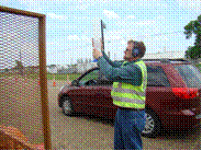 This image shows a crew member determining the total volume of beads that are emptied into the transparent volume gauge by visual observation of the gauge