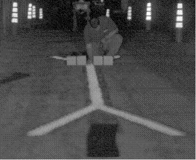This image shows the same as figure 8, and additionally, it shows a crew member holding an illuminance meter at the end of the straight pavement marking sample at the point of bifurcation.
