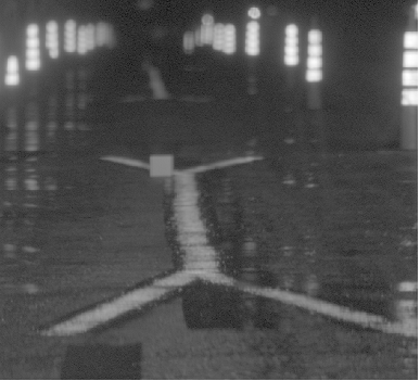 This picture shows the imaging photometer snapshot under rainy condition with a single diffusing panel and an entire test pavement marking and its four tapers, two on either side.