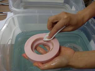 Step 15.4.1. Cleaning mold in soapy water with paper towel.