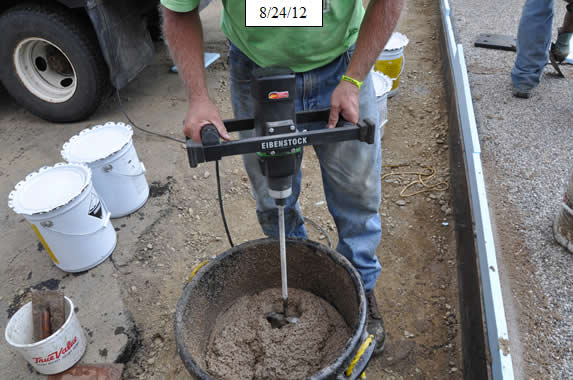 Figure 24. Photo. Mix epoxy grout for deck nosing at bridge joints.