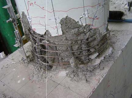 Figure 14. Photo. Condition of the base of column in LB-FB at end of testing. Condition of the plastic hinge region of test specimen LB-FB after testing. Damage is characterized by spalling into the core, fractured transverse reinforcement, buckled and fractured longitudinal reinforcement, and minor spalling at the soffit of the cap beam.