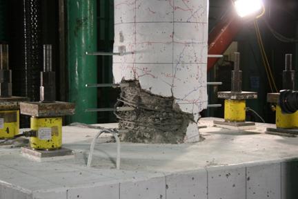 Figure 27. Photo. Specimen SF-2 after completion of cyclic testing. Damage to specimen SF-2 after cyclic testing has been completed, characterized by damage concentrated within the column directly adjacent to the top of the footing, crushed core concrete, fractured spiral, and longitudinal reinforcement. No damage to the footing.