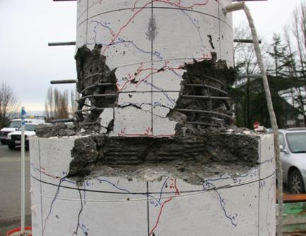 Figure 38. Photo. Specimen DS-1 after testing. Damage to specimen DS-1 after cyclic testing is characterized by concentrated damage to the column directly adjacent to the top of the pile shaft. Core concrete crushing, spiral and longitudinal reinforcement damage are visible, as are minor damage to the unreinforced top several inches of the pile shaft and minor cracking to the shaft itself.