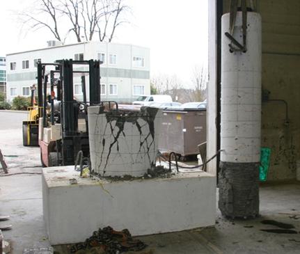 Figure 39. Photo. Specimen DS-2 after testing. Damage to specimen DS-2 after cyclic testing is characterized by no damage to the column except flexural cracking. The top of the pile shaft shows very large diagonal and vertical cracks where the column socket pried the top of the shaft open. The column could be easily lifted out of the top of the shaft after testing.