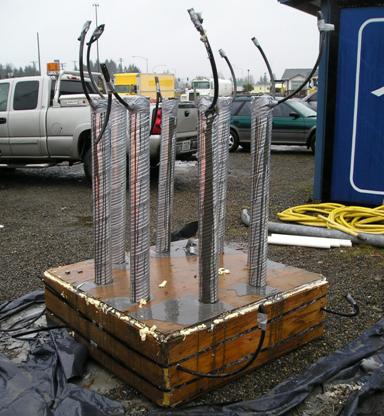 Figure 44. Photo. Mock-up of the grouted joint. The mockup of the grouted joint between the column segments is shown as two plywood boxes with the dimensions of the prototype columns separated by shims. PVC pipes are used to model the rebar within the ducts. The joint was sealed, and the grouting operations were conducted to show that grouting could be accomplished.