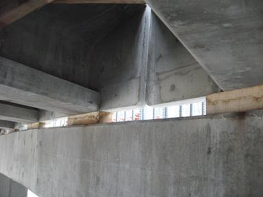 Figure 55. Photo. Girder end wall diaphragms and girders on oak blocks. Precast end wall diaphragms were used as cast-in-place forms for the cast-in-place diaphragm.