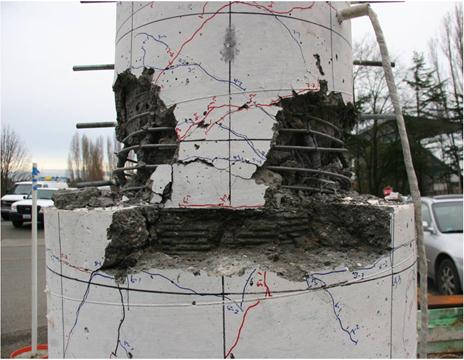 Photo showing the damage in the column at hinge position and in the upper part of the shaft after the tests on specimen DS-1.
