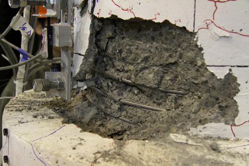 As the column was cycled more, the damage in the plastic hinge region became more pronounced.