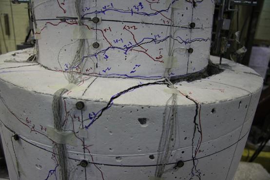 As the column was cycled more, the damage in the shaft region became more pronounced. The photo was taken right after hearing the cracking sound of the shaft spiral in the top of the transition.