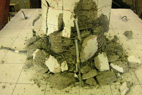 After cyclic testing, the column was pushed axially in an attempt to punch the precast column through the spread footing. The column crushed at 842 kips load before the column could punch through the spread footing.