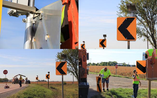 Images: Four images showing installation of the sequential dynamic curve warning system. Images show back side of chevron sign, completed chevrons close up, traffic control while installing sign, and lifting chevron into place.