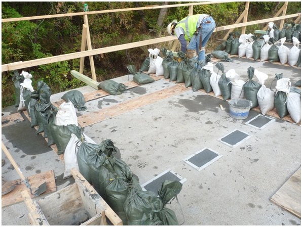 Photo showing the finished transverse connections covered with plywood after completion of pouring on-site UHPC in connection regions