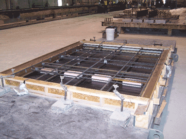 Mild steel reinforcing is placed in the form work.