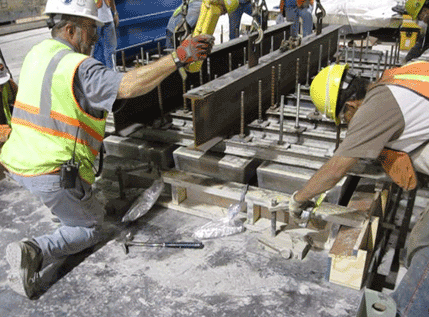 The voids that form the ribs of the panel were placed into the fresh UHPC and displaced the concrete to form the final shape.