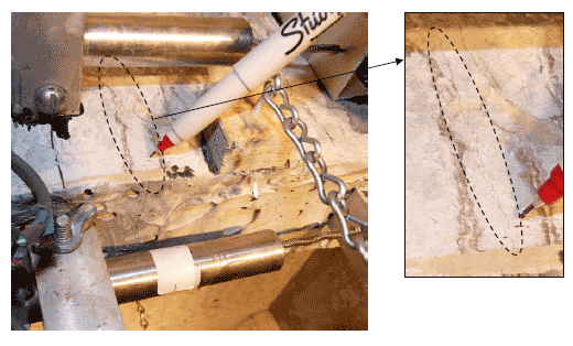 A hairline crack with a width of less than .002" runs across a transverse rib.