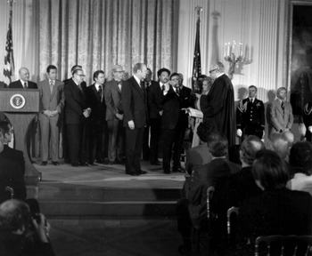 President Gerald R. Ford (left) looks on as Supreme Court Justice Thurgood Marshall administers the oath of office to his friend and colleague, William T. Coleman, Jr., as Secretary of Transportation.