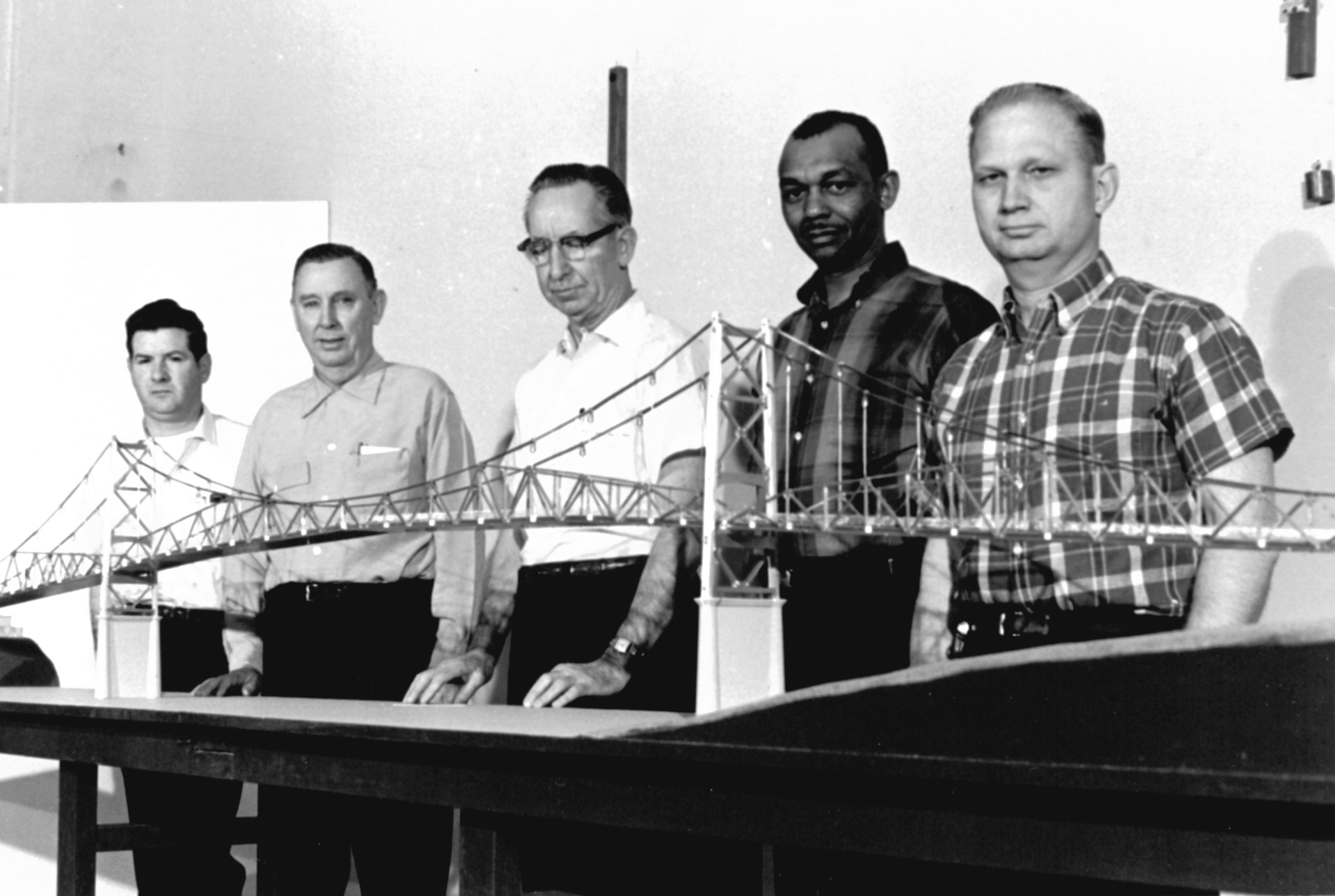 Image of FHWA's Engineering Systems Division scale model of the structure.  Pictured are, from left to right, the model's builders: Robert Taylor, Douglas Chambers, Benjamin Wood, Christopher Hall, and Alvin Pettit. </p>